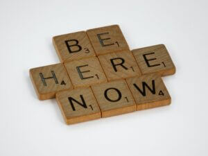 Be Here Now in scrabble letters.
