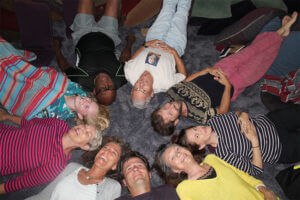 Group of people in a circle with heads together